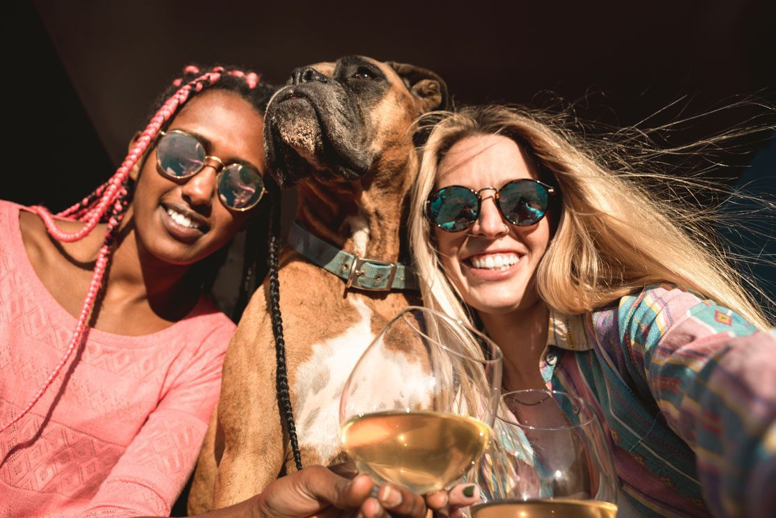 Two women, a dog and white wine.